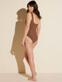 back view of brown square neck one-piece tank swimsuit when worn