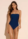 Model wearing Dreamsculpt strapless navy tummy-control bandeau swimsuit on neutral backdrop 