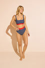Model wearing striped DreamSculpt bikini top and bottom with tummy-control fit against a studio backdrop.